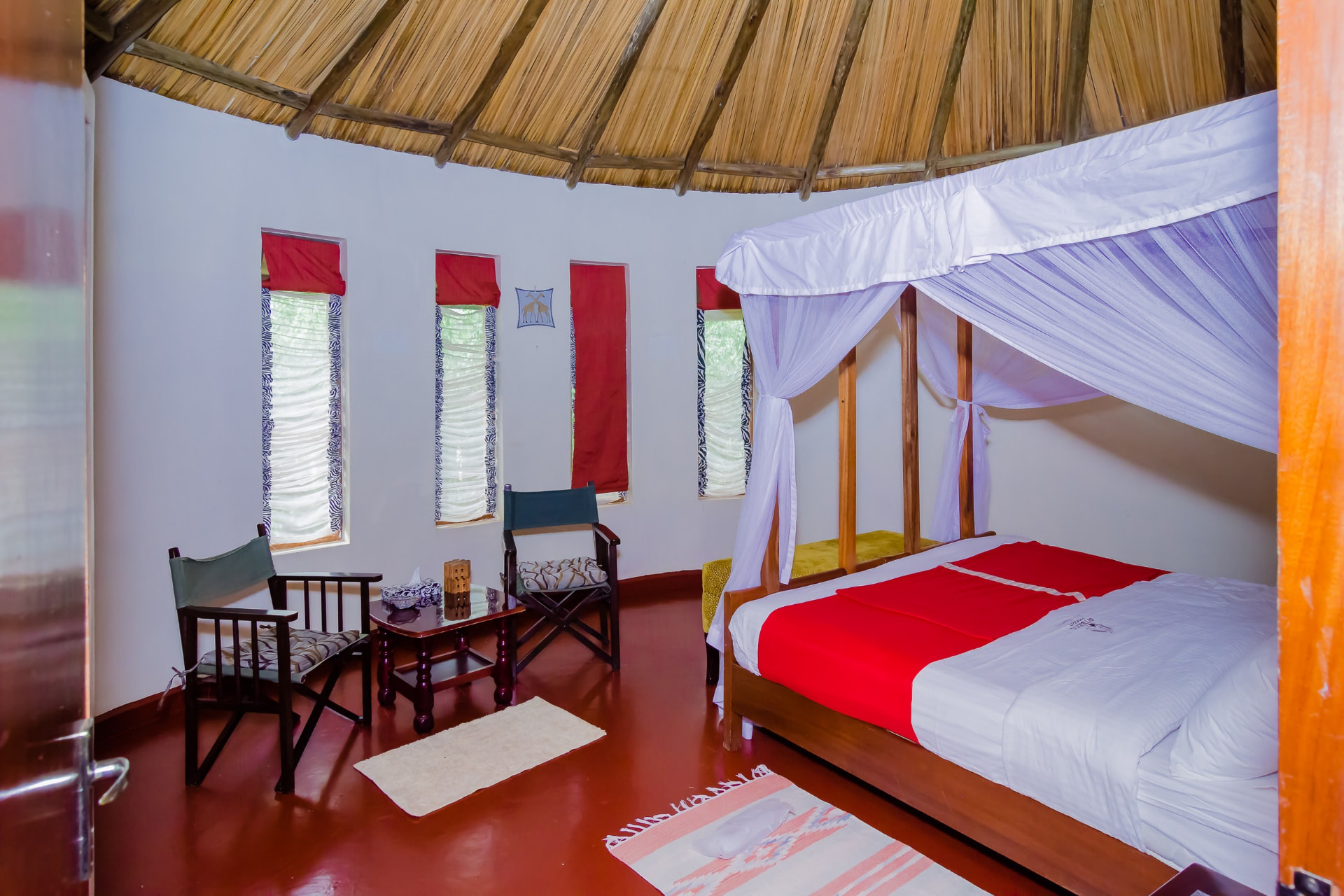 Bedroom seating area beneath a thatched ceiling