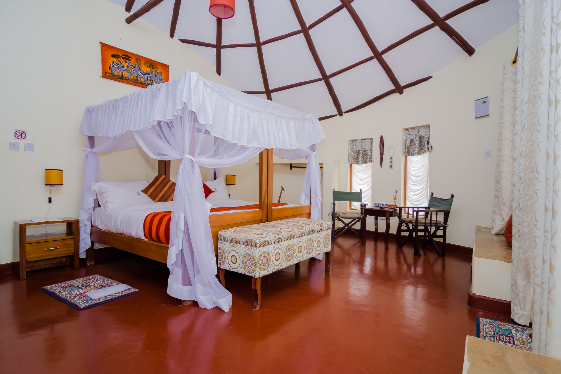 Bedroom with a canopy bed and red linen runner