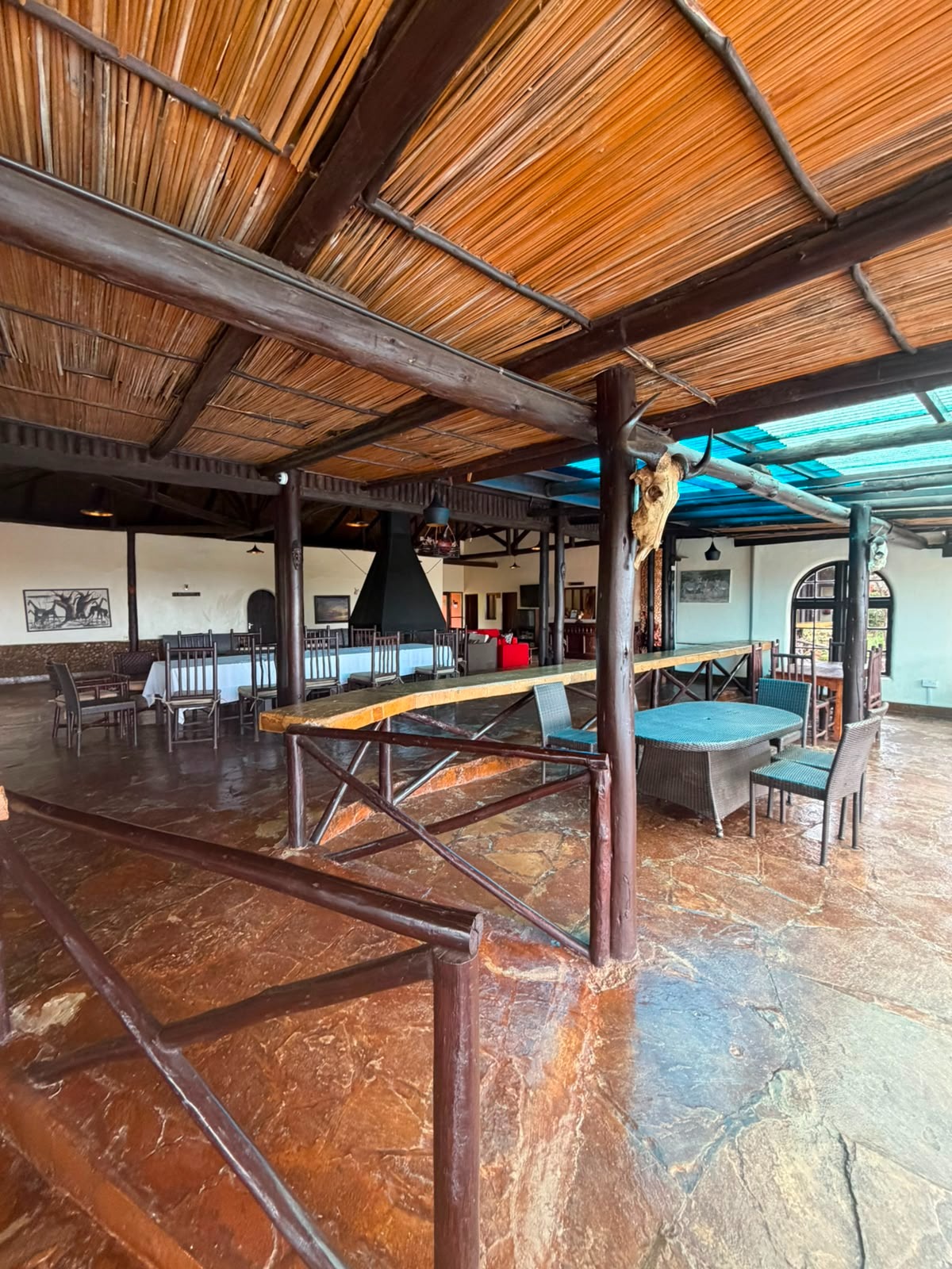 Open-air thatched lounge and dining area at the lodge